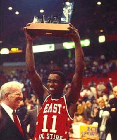 Detroit guard Isiah Thomas lifts the MVP Award he won at the 1984 NBA All-Star Game.